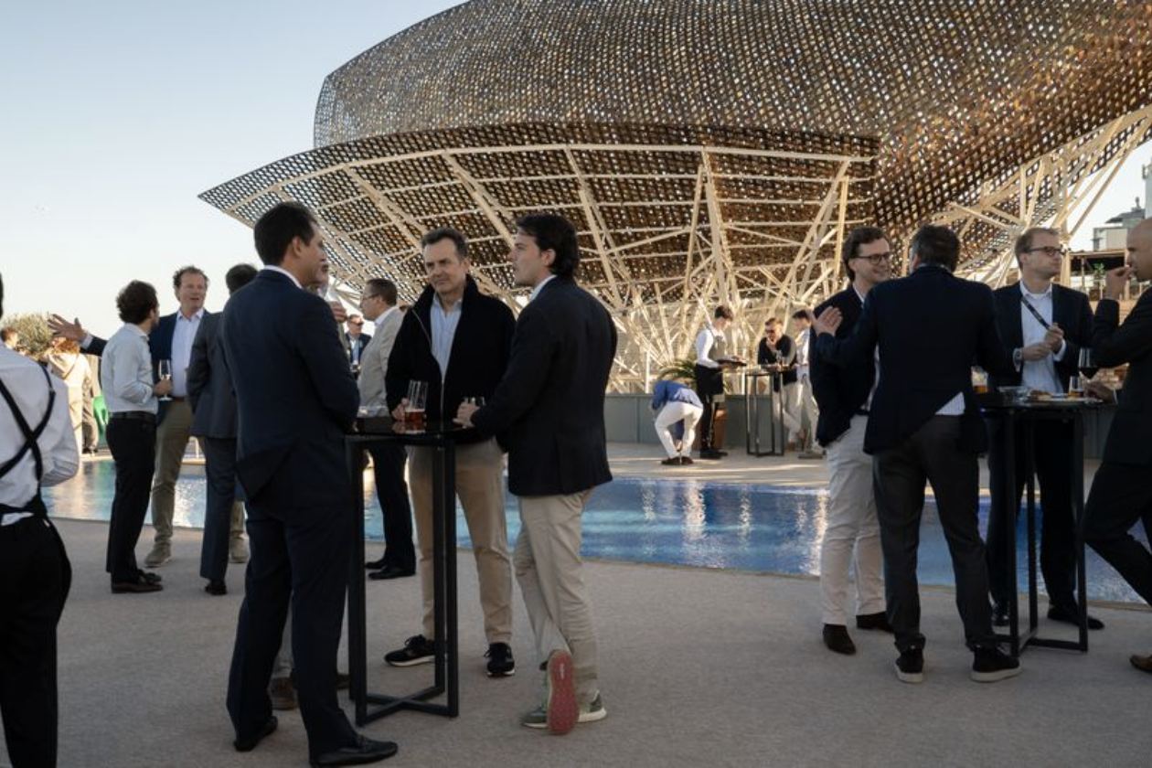 Delegates networking beneath the Peix sculpture during the MGA Rendezvous evening reception